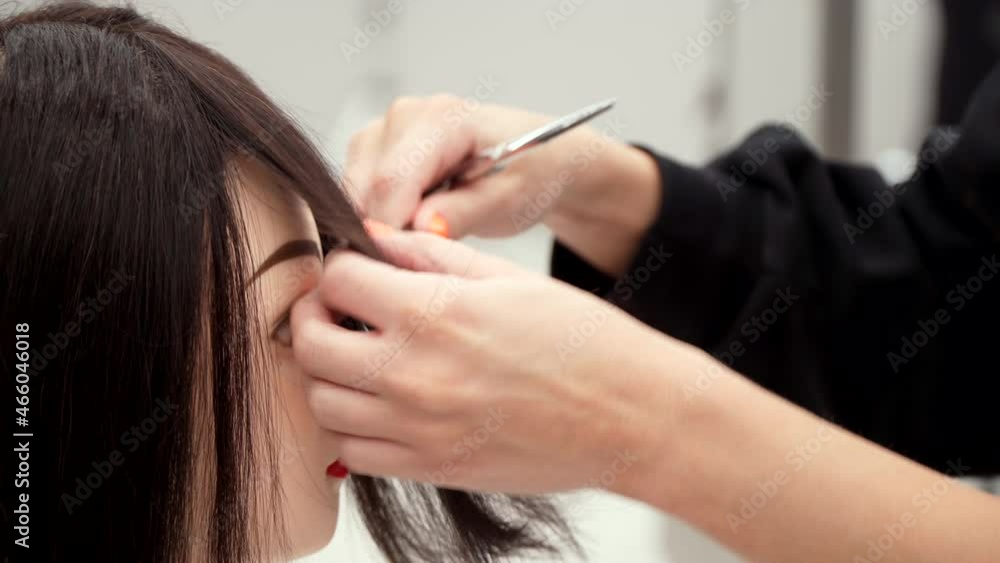 Caucasian girl in black clothes cuts the head of a mannequin Caucasian girl in black clothes cuts the head of a mannequin