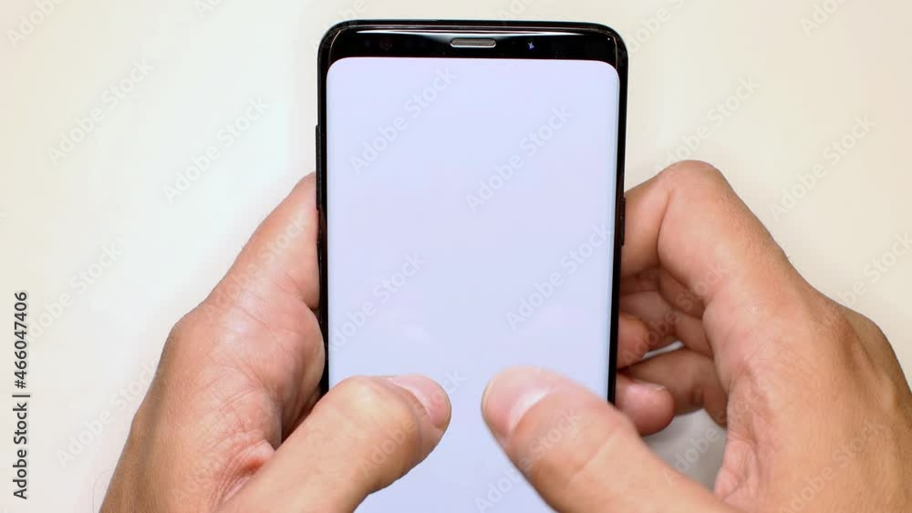 Holding telephone blank minimal template. Man scrolling on smartphone screen with white background. Smartphone template with gesture and scrolling action. Holding telephone blank minimal template. Man scrolling on smartphone screen with white background. Smartphone template with gesture and scrolling action.