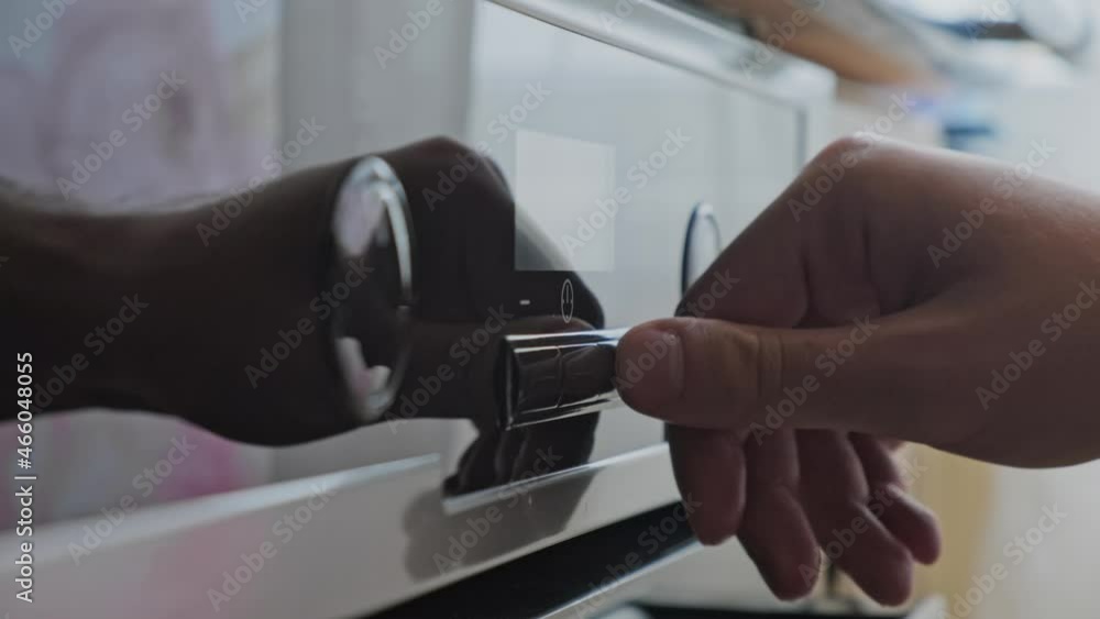 Man setting up the timer on the oven. Man setting up the timer on the oven.