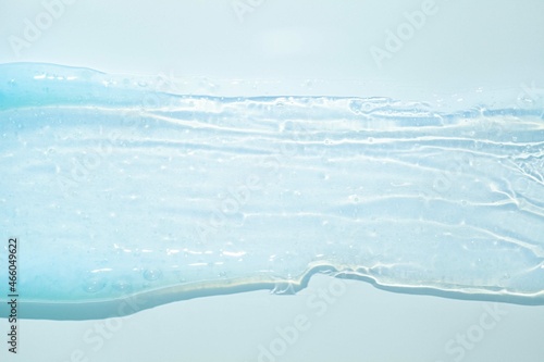 Cream gel transparent cosmetic sample texture on blue background © tatyanarow