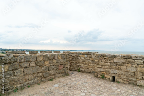 The fortress wall is made of natural stone. Ancient limestone stone. Creative vintage background. Ukraine. Belgorod - Dnestrovsky.