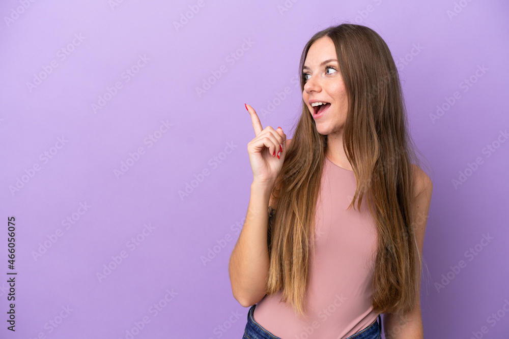 Young Lithuanian woman isolated on purple background intending to realizes the solution while lifting a finger up Young Lithuanian woman isolated on purple background intending to realizes the solution while lifting a finger up