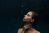 Mermaid. Portrait of young beautiful woman underwater.