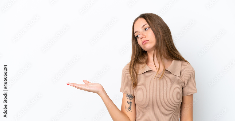 Young Lithuanian woman isolated on white background holding copyspace with doubts Young Lithuanian woman isolated on white background holding copyspace with doubts