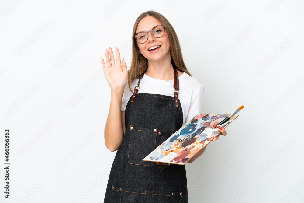 Young artist Lithuanian woman holding a palette isolated on white background saluting with hand with happy expression Young artist Lithuanian woman holding a palette isolated on white background saluting with hand with happy expression