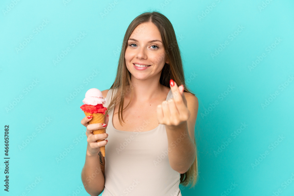 Young Lithuanian woman with cornet ice cream isolated on blue background making money gesture Young Lithuanian woman with cornet ice cream isolated on blue background making money gesture