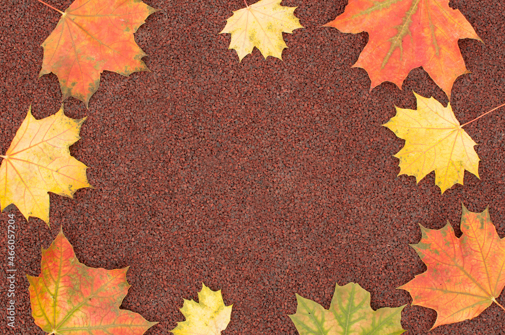 autumn brown background with red and yellow maple leaves on the edges of the frame with space for text autumn brown background with red and yellow maple leaves on the edges of the frame with space for text