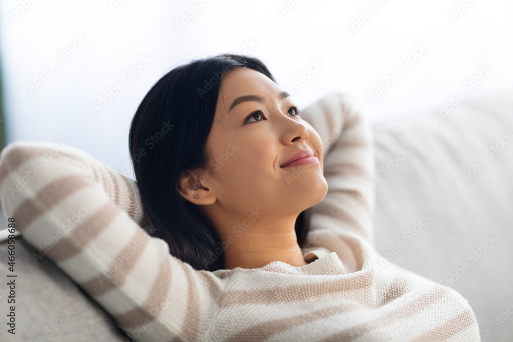 Portrait Of Calm Beautiful Young Asian Female Leaning Back On Comfortable Couch Portrait Of Calm Beautiful Young Asian Female Leaning Back On Comfortable Couch