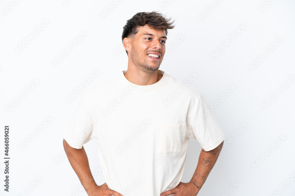 Young caucasian handsome man isolated on white background posing with arms at hip and smiling Young caucasian handsome man isolated on white background posing with arms at hip and smiling