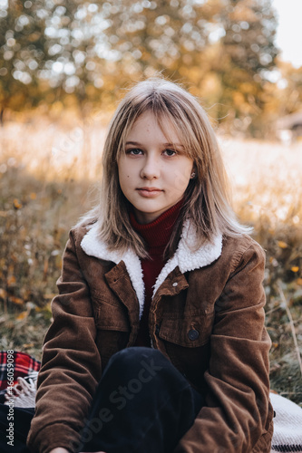 Сozy autumn photo portrait of a young beautiful teen girl outdoors.
