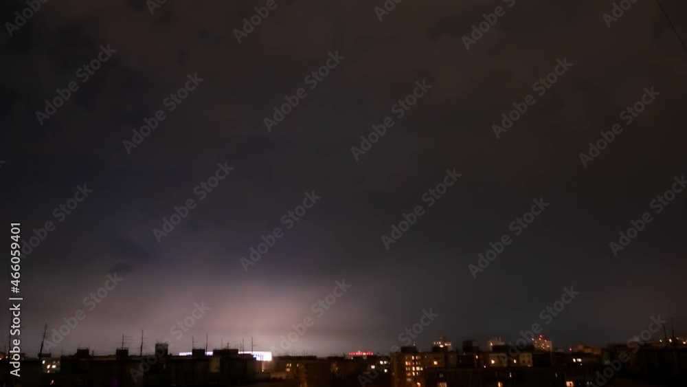 Timelapse - dark stormy sky with lightning strikes and fast moving thunderstorm clouds over city at night. Dramatic, nature, danger, weather, time lapse concept Timelapse - dark stormy sky with lightning strikes and fast moving thunderstorm clouds over city at night. Dramatic, nature, danger, weather, time lapse concept