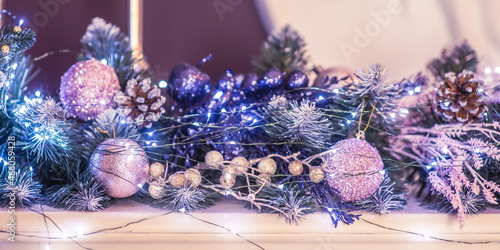 Christmas tree in toys and garlands. Christmas ornament. Decorating a branch of a Christmas tree for the new year.