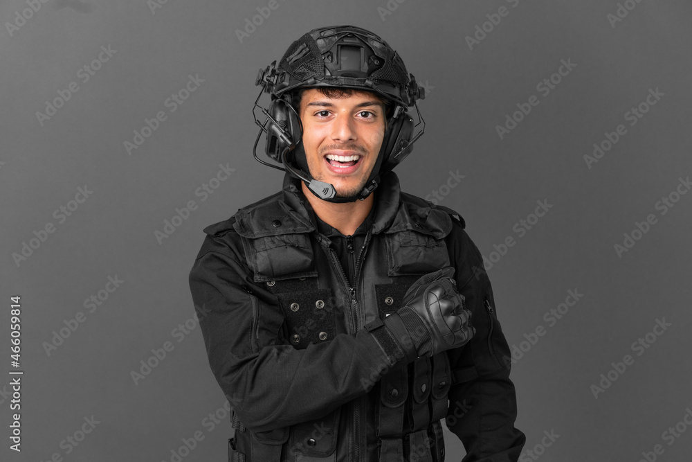 SWAT caucasian man isolated on grey background celebrating a victory SWAT caucasian man isolated on grey background celebrating a victory