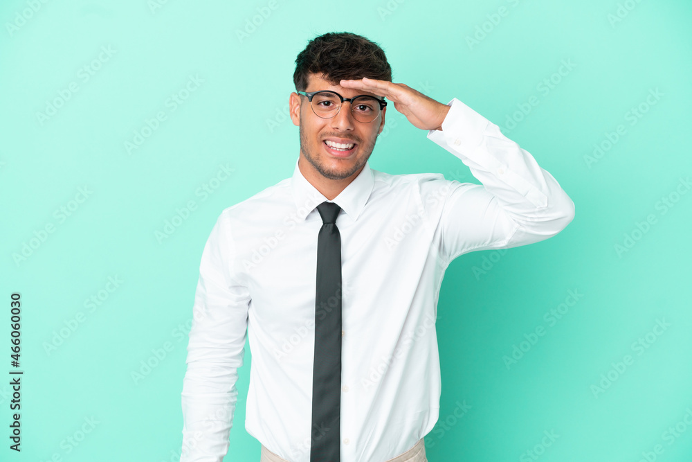 Business caucasian man isolated on blue background looking far away with hand to look something Business caucasian man isolated on blue background looking far away with hand to look something