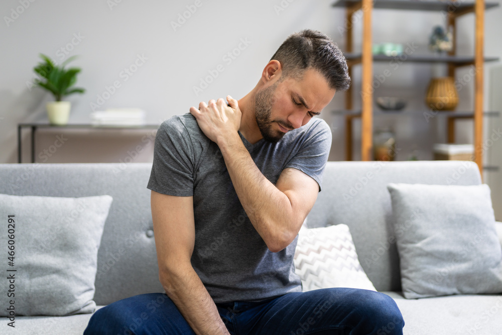 Man With Shoulder Pain At Couch