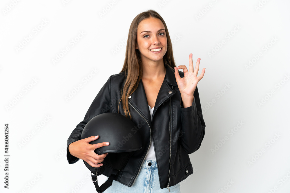 Woman with a motorcycle helmet over isolated white background showing ok sign with fingers Woman with a motorcycle helmet over isolated white background showing ok sign with fingers