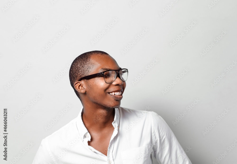 Head shot with copy space of a cheerful black man happy with glasses looking away. Head shot with copy space of a cheerful black man happy with glasses looking away.