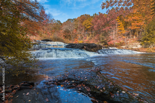 Shohola Falls in the Pennsylvania Poconos on a beautiful fall morning surrounded by peak fall foliage. Waterfalls in the fall.