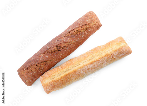 Different tasty baguettes on white background, top view. Fresh bread