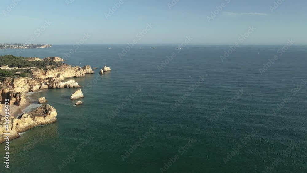 Aerial seascape view of Alvor prainha cliffs and cape João de Arens, tourist destination in Western Algarve Coast, Portugal. Aerial seascape view of Alvor prainha cliffs and cape João de Arens, tourist destination in Western Algarve Coast, Portugal.