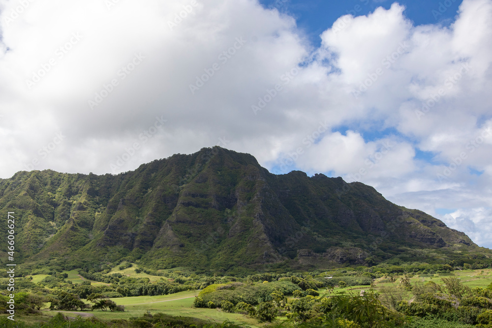 Green mountains with blue cloudy sky. Hawaii