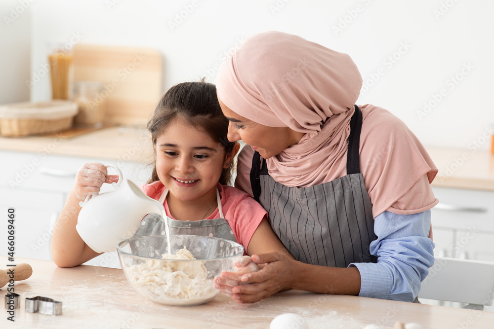 Cooking Together. Muslim Mother Baking With Her Little Daughter In Kitchen Cooking Together. Muslim Mother Baking With Her Little Daughter In Kitchen