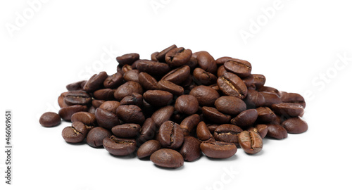 Pile of roasted coffee beans on white background