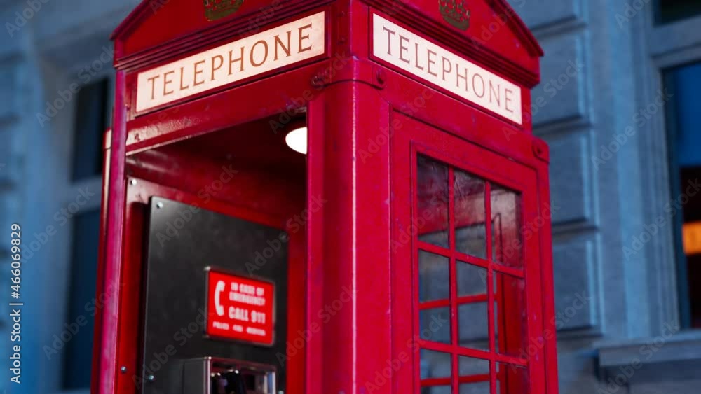 Red British phone booth with a hanging receiver on the wall. London symbol. Red British phone booth with a hanging receiver on the wall. London symbol.