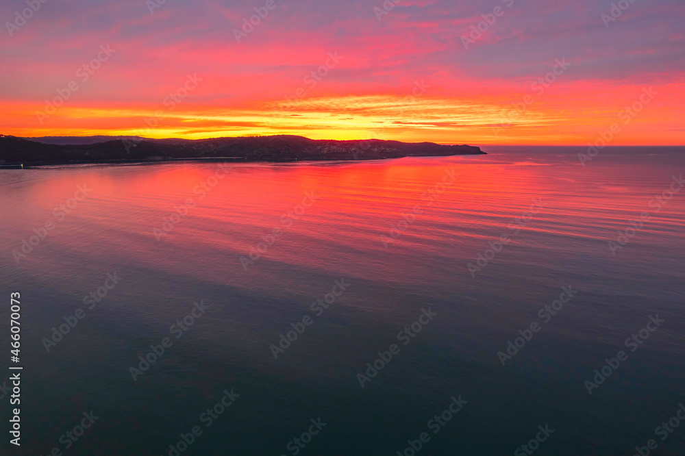 Obraz premium One hundred percent colourful cloud covered sunrise over the sea
