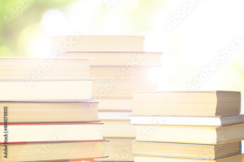 Stacks of books on blurred background. Bokeh effect