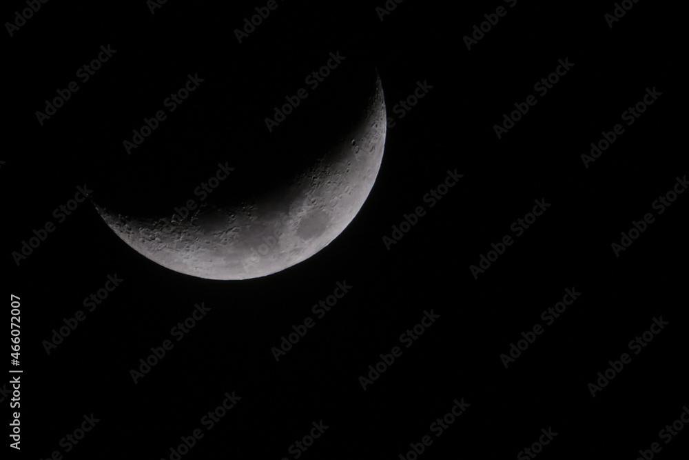 Crescent moon in dark winter sky with black background Crescent moon in dark winter sky with black background