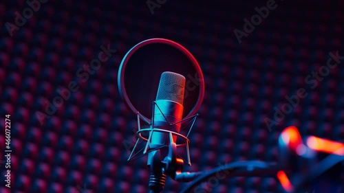 Studio condenser microphone with pop filter in red and blue light