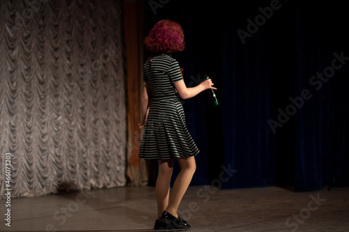 Cuadro en lienzo A girl on stage with a microphone