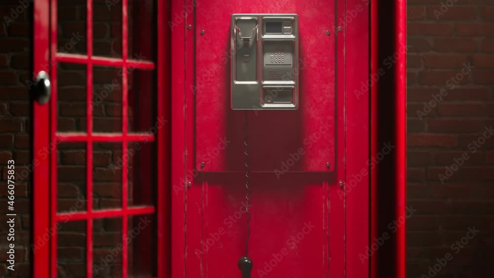 Black handset hanging in a red telephone box. Footage with a British phone booth Black handset hanging in a red telephone box. Footage with a British phone booth
