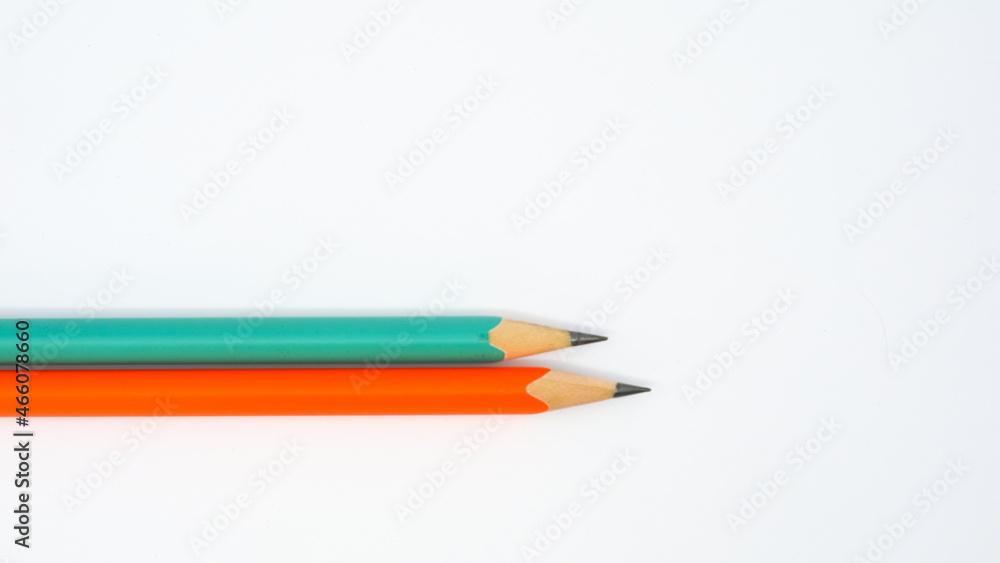 Pencils placed on white paper background with copy space for your image or text. Pencils placed on white paper background with copy space for your image or text.