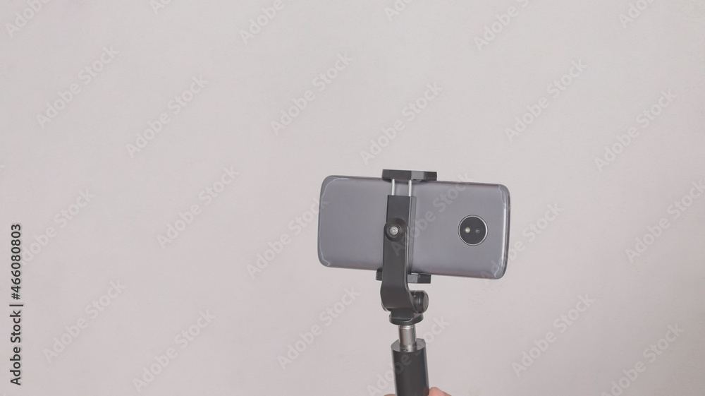 Cell phone mounted on a cell phone tripod, on white background. Cell phone mounted on a cell phone tripod, on white background.