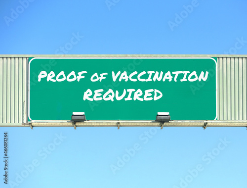 Proof of Vaccination Required road sign. Blue sky background
