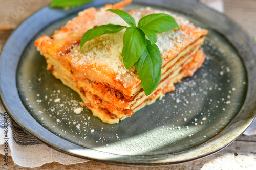  Delicious Home made keto diet Lasagna bolognese with Lupin Flour, minced meat,tomato sauce and spinach on a wooden rustic background.Home made low carb italian meal