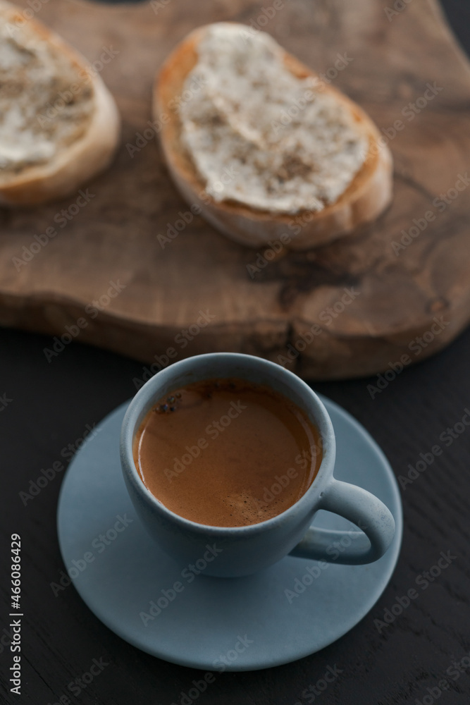 Espresso in blue cup with sandwiches with cream cheese on background Espresso in blue cup with sandwiches with cream cheese on background