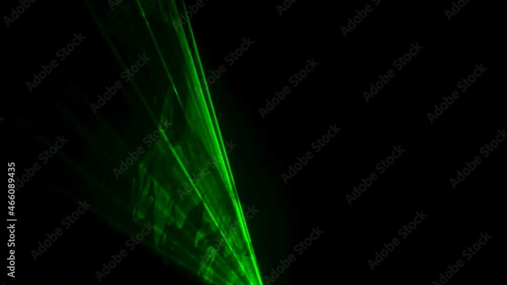 Dynamic green beams of laser neon light on black studio background spinning in puffs of smoke. Show of stage holograms. Lighting equipment and effects for holidays and parties. Close up. Dynamic green beams of laser neon light on black studio background spinning in puffs of smoke. Show of stage holograms. Lighting equipment and effects for holidays and parties. Close up.