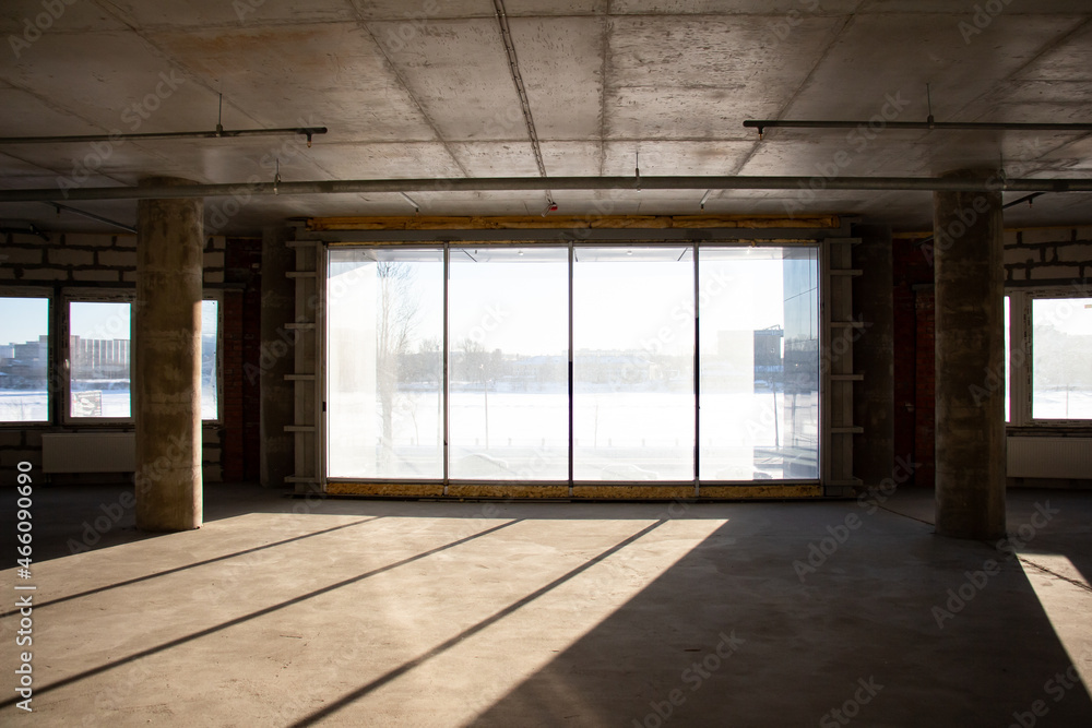 Empty full of light hall with columns before repair and renovation Empty full of light hall with columns before repair and renovation