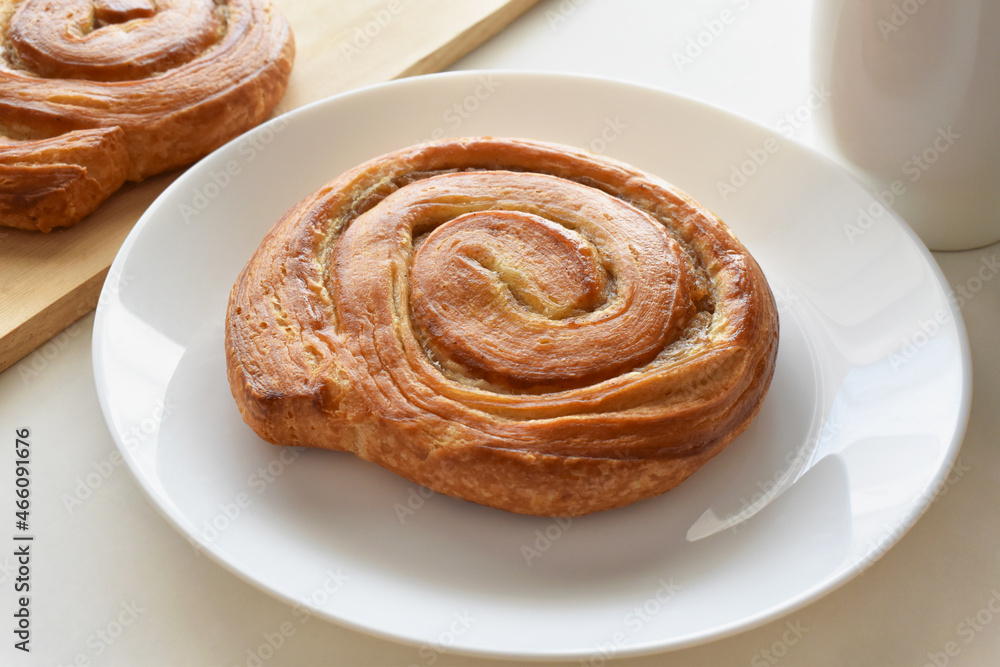 Danish pastry swirl on a white plate. 