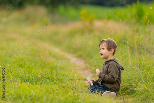 Little boy with flower in countryside road