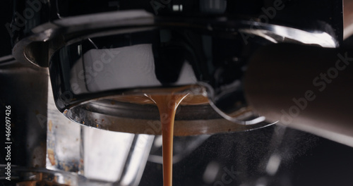 espresso pour from bottomless portafilter closeup