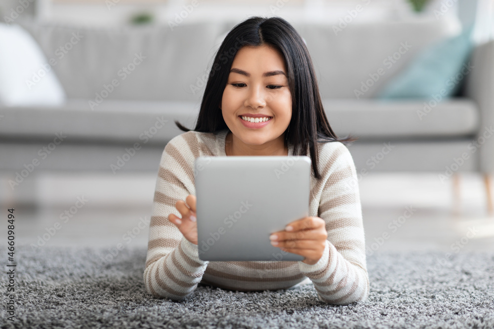 Technologies For Leisure. Beautiful Asian Female Relaxing With Digital Tablet At Home Technologies For Leisure. Beautiful Asian Female Relaxing With Digital Tablet At Home