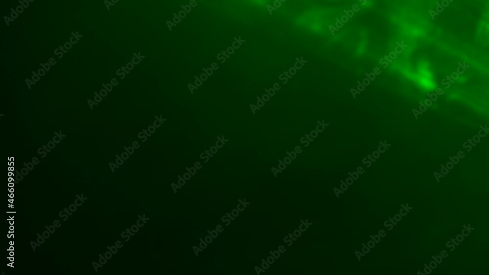 Bright beams of green neon laser light flashes and emitting lights in a smoky dark studio. Stage lights. Lighting, illumination, theatrical smoke on stage. Holiday, night club, disco, party. Close up. Bright beams of green neon laser light flashes and emitting lights in a smoky dark studio. Stage lights. Lighting, illumination, theatrical smoke on stage. Holiday, night club, disco, party. Close up.