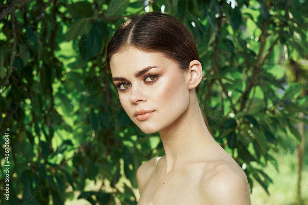 portrait of a woman green leaves clean skin nature summer close-up portrait of a woman green leaves clean skin nature summer close-up