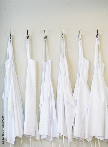 White Apron Hanging, Chef Clothes Hanging in Kitchen.