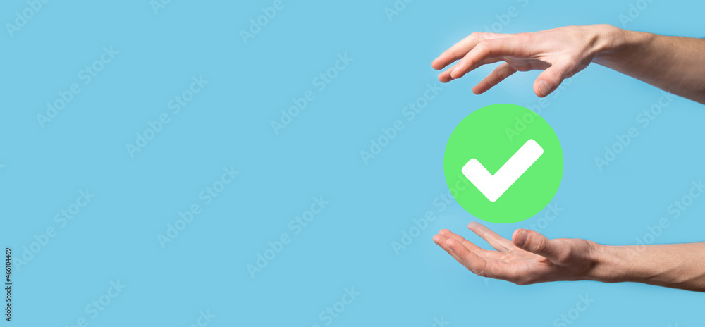 Hand holds green icon Check mark,Check Mark Sign, Tick Icon,right sign,circle green checkmark button,Done.On dark background.Banner.Copy space.Place for text. Hand holds green icon Check mark,Check Mark Sign, Tick Icon,right sign,circle green checkmark button,Done.On dark background.Banner.Copy space.Place for text.