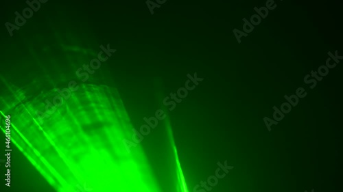 Bright green neon laser lights flashing during concert on black smoky background stage. Laser lights move in puffs of smoke. Professional color lighting and light show effects for party. Close up. photo